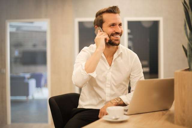 a property manager smiling while taking a phone call